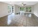 Bright living room featuring tile floors, large windows, and sliding glass doors to outdoor area at 6902 Lakeview Ct, Tampa, FL 33634