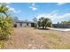 Backyard with tropical plants and small pool, viewed from a distance on a clear day at 75 Virginia Ct, Englewood, FL 34223