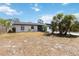 Backyard of home with partially bare yard, a privacy fence, and sliding door access to the residence at 75 Virginia Ct, Englewood, FL 34223