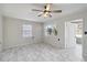 Well-lit bedroom featuring tile floors, neutral walls, and natural light from large windows at 75 Virginia Ct, Englewood, FL 34223