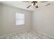 Bright bedroom with tile floors, neutral walls, a window, and ceiling fan at 75 Virginia Ct, Englewood, FL 34223