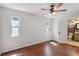 Well-lit bedroom with hardwood floors and an en suite bathroom visible through the doorway at 75 Virginia Ct, Englewood, FL 34223