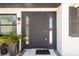 Elegant dark-colored front door featuring sidelights and decorative accents, enhancing the home's curb appeal at 75 Virginia Ct, Englewood, FL 34223