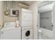 Functional laundry area featuring a stacked washer and dryer setup and laundry sink at 75 Virginia Ct, Englewood, FL 34223