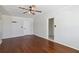 Bright room with hardwood flooring, neutral walls, and ceiling fans at 75 Virginia Ct, Englewood, FL 34223