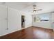 Inviting living area with hardwood floors, a ceiling fan, and a view leading into the kitchen at 75 Virginia Ct, Englewood, FL 34223