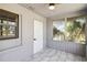 Cozy sunroom features tiled floor and a view of the lush greenery outside at 75 Virginia Ct, Englewood, FL 34223