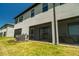 Exterior view of the home's screened-in patio and grassy backyard at 15242 Sunny Day Dr, Bradenton, FL 34211