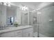 Well-lit bathroom featuring a double vanity with granite countertop and glass-enclosed shower at 15242 Sunny Day Dr, Bradenton, FL 34211