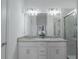 Bright bathroom featuring a double vanity with granite countertop and glass-enclosed shower at 15242 Sunny Day Dr, Bradenton, FL 34211