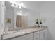 Bathroom with a large mirror, granite countertops, and modern fixtures at 15242 Sunny Day Dr, Bradenton, FL 34211
