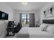 Bedroom featuring neutral décor, a large window, and a dedicated desk area at 15242 Sunny Day Dr, Bradenton, FL 34211