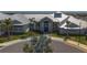 Community clubhouse featuring lush landscaping, ample parking, and a welcoming entrance at 15242 Sunny Day Dr, Bradenton, FL 34211