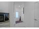 Well-lit hallway with a patterned rug and multiple access doors at 15242 Sunny Day Dr, Bradenton, FL 34211