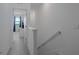 Bright hallway featuring neutral carpet, white walls, and a glimpse into a well-lit bedroom at 15242 Sunny Day Dr, Bradenton, FL 34211