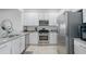 Bright kitchen features stainless steel appliances, granite countertops, and white cabinets at 15242 Sunny Day Dr, Bradenton, FL 34211
