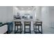 Open kitchen with granite countertop bar and modern pendant lighting offers a cozy breakfast spot at 15242 Sunny Day Dr, Bradenton, FL 34211