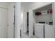 Clean laundry room features modern appliances and shelving for ample storage at 15242 Sunny Day Dr, Bradenton, FL 34211