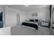 This neutral main bedroom boasts a stylish queen bed, and large windows for natural light at 15242 Sunny Day Dr, Bradenton, FL 34211