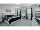 Bright, airy main bedroom features modern furnishings, a large mirror, and scenic outdoor views at 15242 Sunny Day Dr, Bradenton, FL 34211