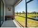Screened patio with bench seating overlooking a lush, well-manicured yard and a pond at 15242 Sunny Day Dr, Bradenton, FL 34211