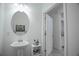 Bright powder room with pedestal sink and nearby doorway at 15242 Sunny Day Dr, Bradenton, FL 34211