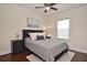 Comfortable bedroom with dark wood floors, ceiling fan, and natural light from the window at 1966 Hyde Park St, Sarasota, FL 34239