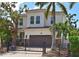 Stunning two-story home with a gated entrance, beautiful landscaping, and tile roof at 1966 Hyde Park St, Sarasota, FL 34239
