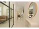 Bright hallway with modern decor, stylish mirror, sleek console table, and porcelain flooring at 1966 Hyde Park St, Sarasota, FL 34239