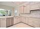 Bright kitchen features stainless steel appliances, marble backsplash, and granite countertops at 1966 Hyde Park St, Sarasota, FL 34239