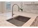 Close-up of the kitchen sink with a granite countertop and stainless steel faucet at 1966 Hyde Park St, Sarasota, FL 34239