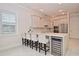 Modern kitchen with a breakfast bar, wine fridge, and stainless steel appliances at 1966 Hyde Park St, Sarasota, FL 34239