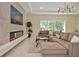 Cozy living room with a modern fireplace, large windows, and comfortable sectional sofa at 1966 Hyde Park St, Sarasota, FL 34239