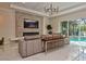 Bright living room with a modern fireplace, large windows, and views of the pool area at 1966 Hyde Park St, Sarasota, FL 34239
