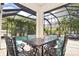 Outdoor dining area featuring a table, chairs, and view of the pool and tropical landscaping at 1966 Hyde Park St, Sarasota, FL 34239