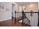 Staircase with dark hardwood floors and black wrought iron railing at 1966 Hyde Park St, Sarasota, FL 34239