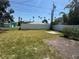 Spacious backyard with lush lawn, white fence, and brick patio is perfect for outdoor activities at 3735 Alabama Ne Ave, St Petersburg, FL 33703