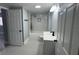 A stunning, newly remodeled bathroom featuring a tub, white marble tile surround, and stylish black fixtures at 3735 Alabama Ne Ave, St Petersburg, FL 33703