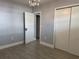 A comfortable bedroom features tile flooring, closet storage, and a modern lighting fixture at 3735 Alabama Ne Ave, St Petersburg, FL 33703