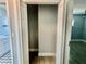 A well-lit walk-in closet featuring neutral gray walls and wood look floors is perfect for storage at 3735 Alabama Ne Ave, St Petersburg, FL 33703