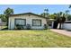 Inviting single-story house with lush greenery and a brick driveway leading to the entrance at 3735 Alabama Ne Ave, St Petersburg, FL 33703