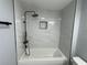 A newly installed bathtub with stunning white marble tile and chic black hardware is move-in ready at 3735 Alabama Ne Ave, St Petersburg, FL 33703