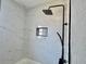 Modern shower with white marble tile, sleek black hardware and a built in shelf at 3735 Alabama Ne Ave, St Petersburg, FL 33703