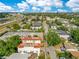Wide aerial shot showcasing townhomes with a red tile roof, nearby highway, and the distant city skyline at 4409 W Gray St # 5, Tampa, FL 33609