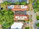 Aerial rooftop perspective reveals townhomes with terra cotta tile roofs, AC units, and convenient street parking at 4409 W Gray St # 5, Tampa, FL 33609