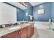 Bathroom with granite counters, double sinks, and a soaking tub at 4409 W Gray St # 5, Tampa, FL 33609