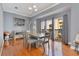 Elegant dining room with a gray wood table set, hardwood floors, and balcony access at 4409 W Gray St # 5, Tampa, FL 33609