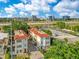 Charming multi-Gathering residence featuring terra cotta tile roof, set against a backdrop of lush greenery and city buildings at 4409 W Gray St # 5, Tampa, FL 33609