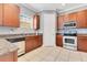 Cozy kitchen with stainless steel appliances, granite counters, and wood cabinets at 4409 W Gray St # 5, Tampa, FL 33609