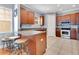 Open kitchen with stainless appliances, granite counters, and breakfast bar at 4409 W Gray St # 5, Tampa, FL 33609